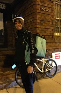 A Deliveroo employee out delivering food.