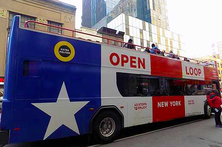 A tourist bus as it travels throughout New York City.