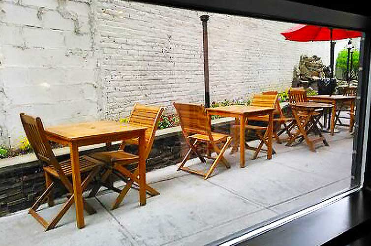A view of the outdoor seating at a New York City Cafe