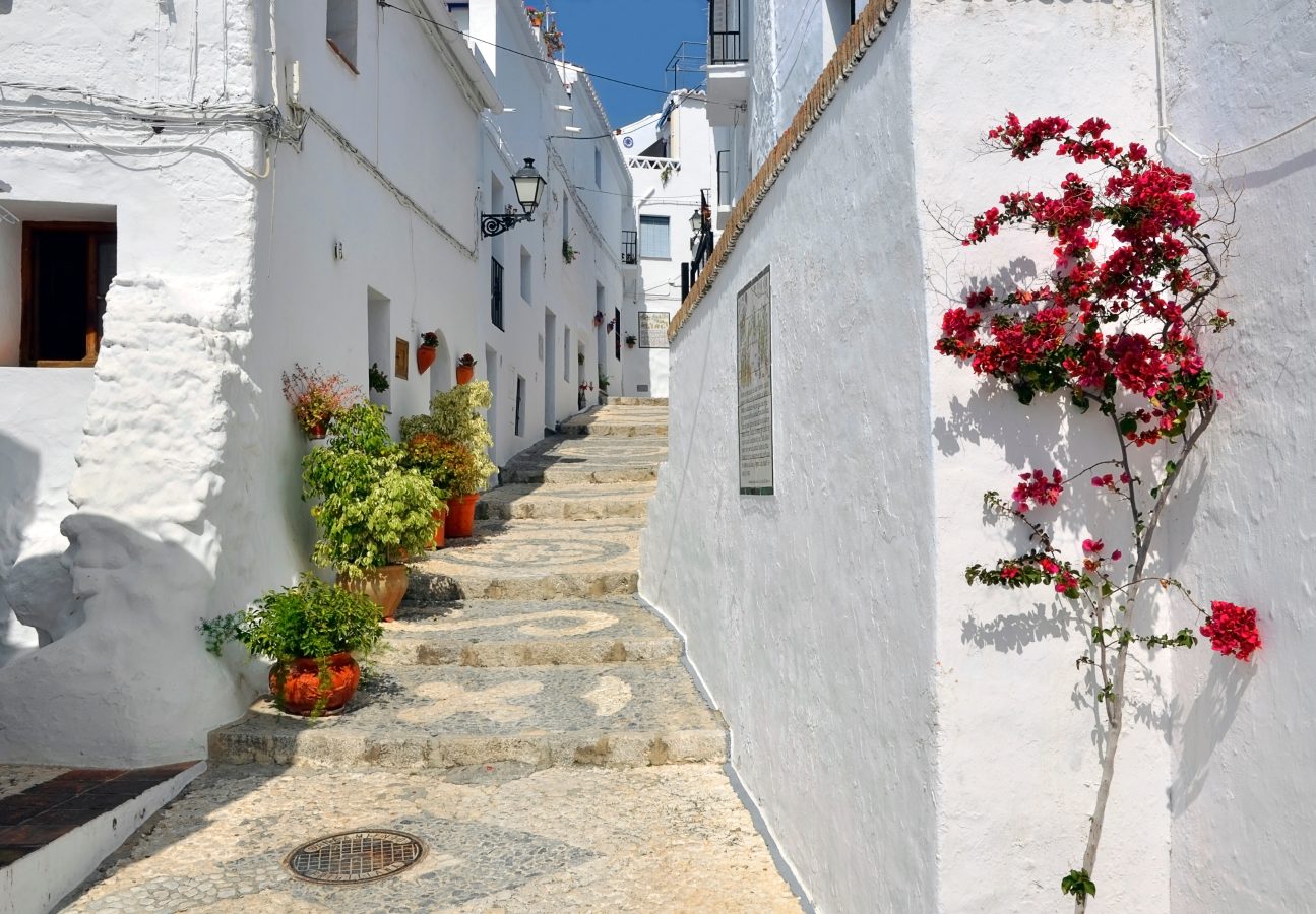 Townhouses along a typical whitewashed village street, Frigiliana, Andalusia, Spain.