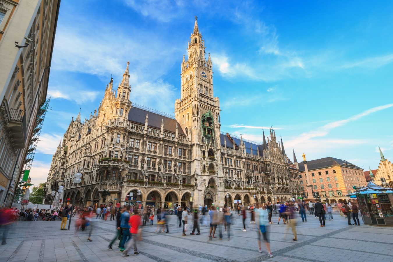 Marienplatz town hall in Munich, Germany busy with people walking around on a sunny day.