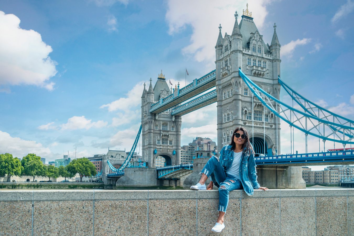 Student on a city trip in London by the river Thames in London, with Tower Bridge in background