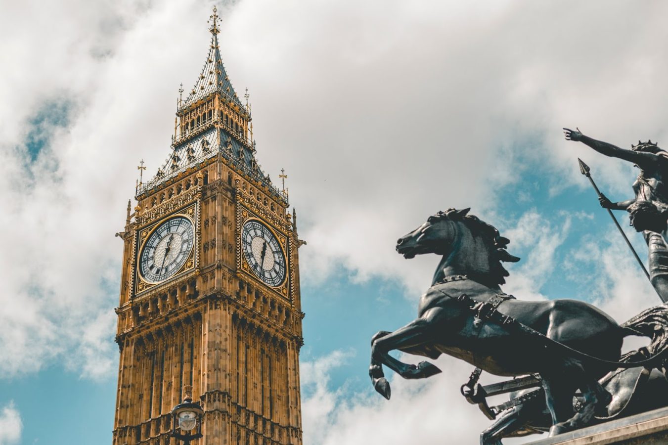 Big Ben clock tower and a statue of a horse in London, England - the destination to travel to for Education majors.