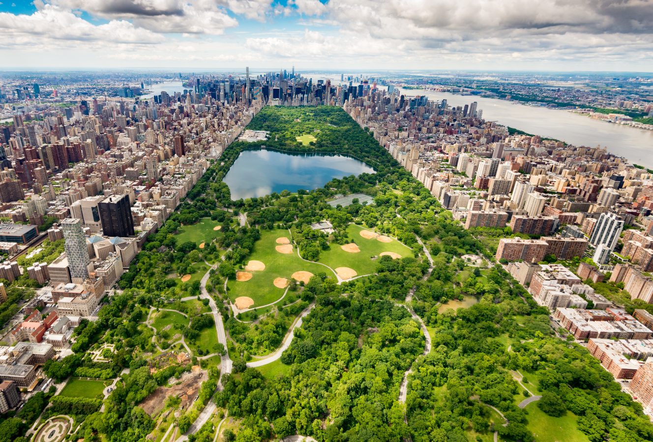 Aerial view of Central Park, NYC - bright green in summer. New York is a perfect last-minute summer travel destination.