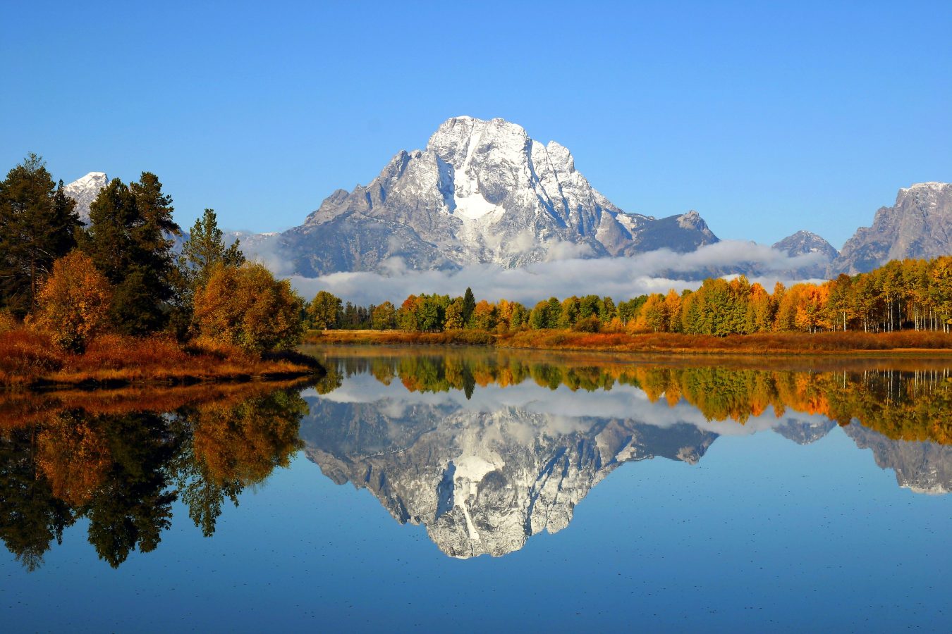 Reflection of the mountain range in a lake at Grand Teton National Park.