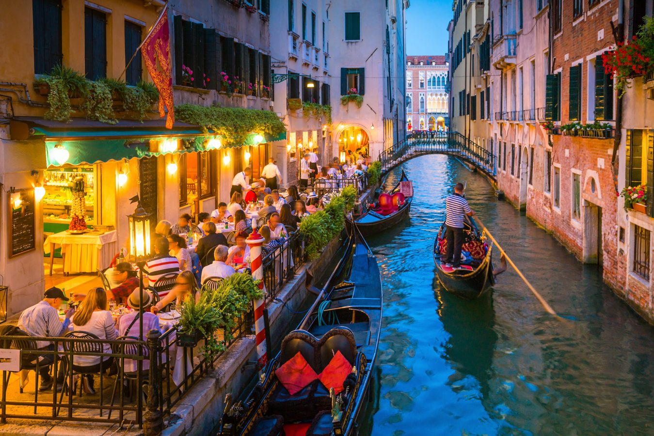 View of canal in Venice Italy at night. Italy's shoulder seasons are from March to April and from September to October.