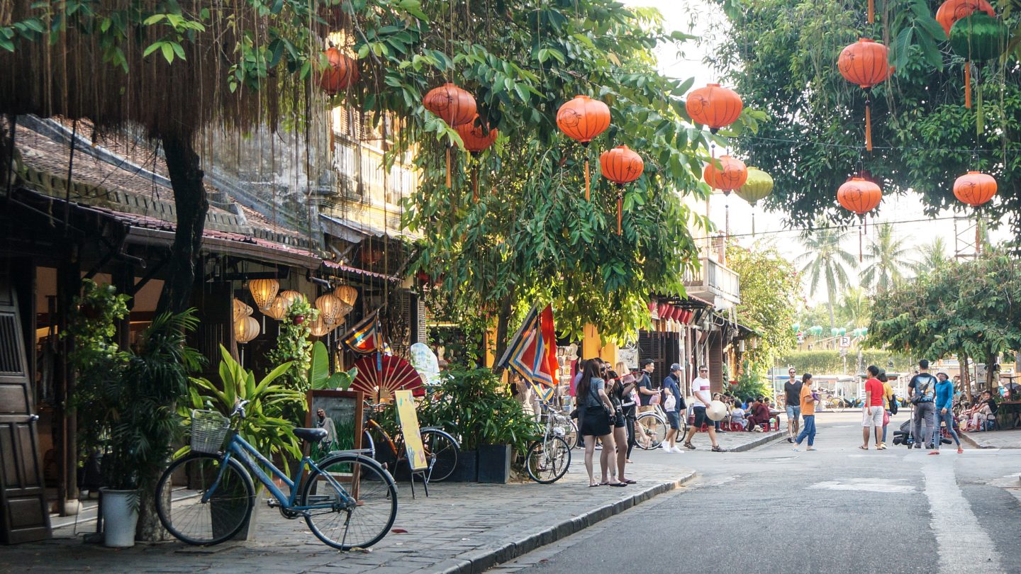 A village street in Vietnam with lanterns hanging above.