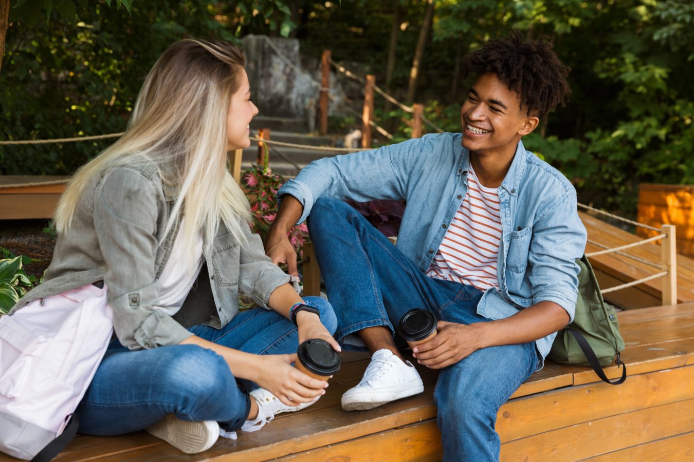 Two young adults sit and chat while participating in a exchange program abroad.