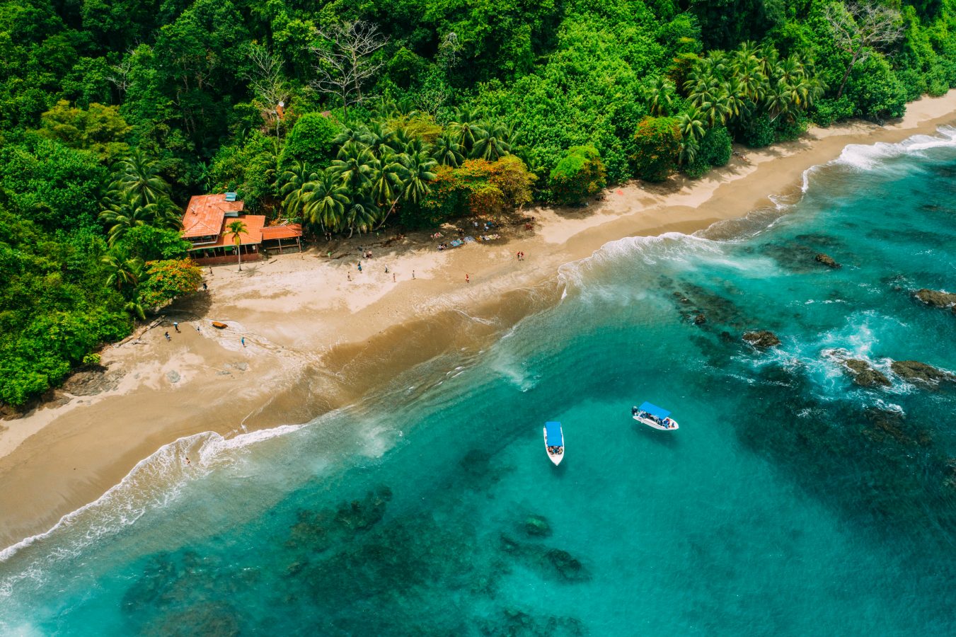 Aerial view of a beach in Costa Rica with the jungle behind the sandy beach. Costa Rica is a popular place to travel to and is one of the cheapest destinations for 2024.
