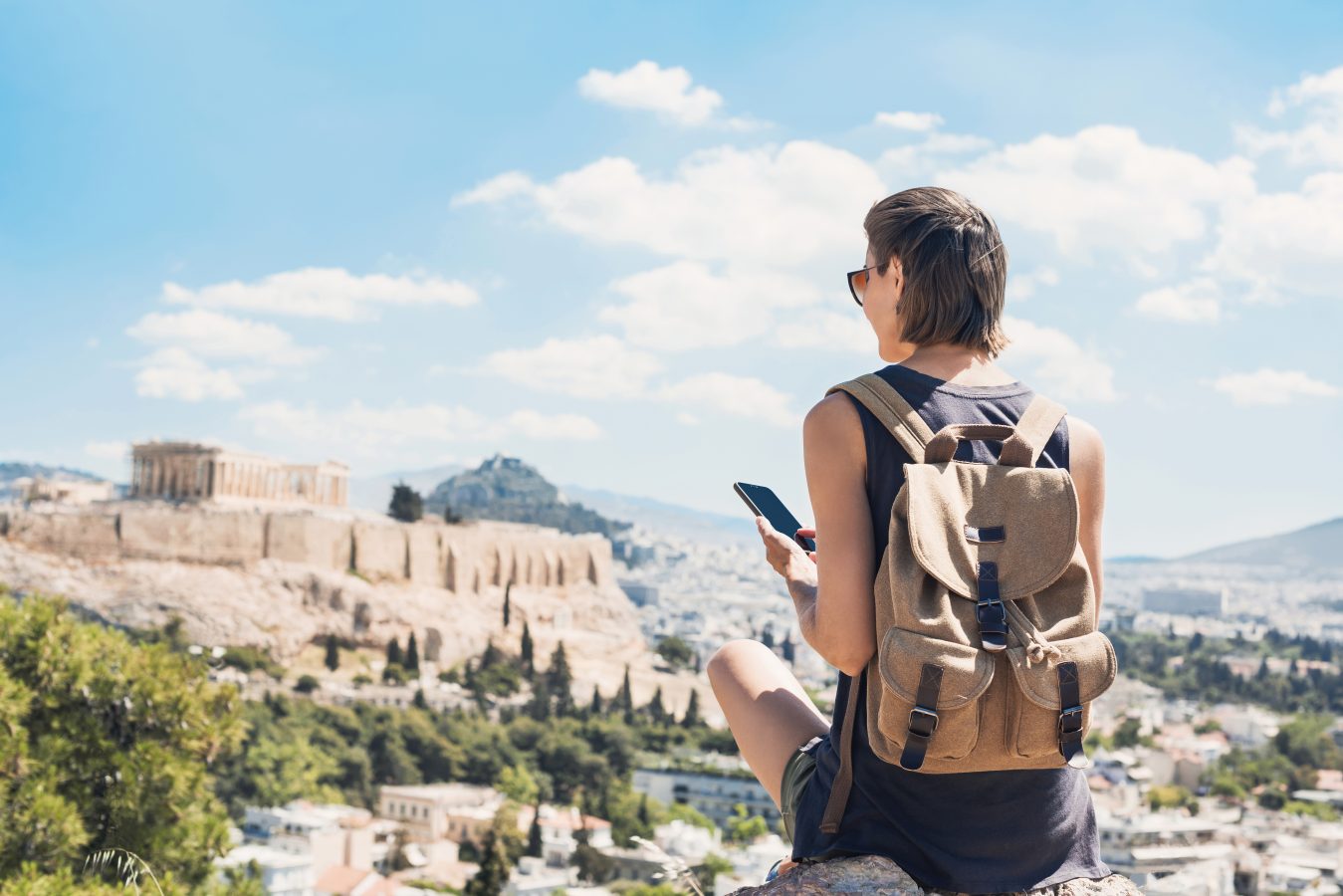 A traveler overlooks the acropolic in Greece, as she used her travel as a means to achieve academic growth as a form of cultural benefits of student travel.